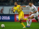 Romania's midfielder Lucian Sanmartean (L) and Hungary's defender Tamas Kadar vie for the ball during the Euro 2016 Group F qualifying football match on October 11, 2014