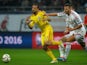 Romania's midfielder Lucian Sanmartean (L) and Hungary's defender Tamas Kadar vie for the ball during the Euro 2016 Group F qualifying football match on October 11, 2014