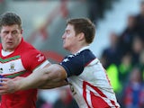 Larne Patrick of Wales is held up by Mark Offerdahl of USA during the Rugby League World Cup Group D match between Wales and USA at the Glyndwr University Racecourse Stadium on November 3, 2013