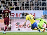 Sweden's forward Ola Toivonen scores past Russia's goalkeeper Igor Akinfeev on October 9, 2014