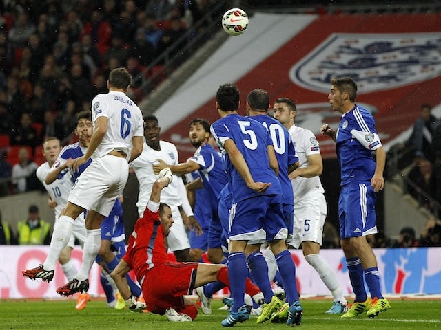 England's defender Phil Jagielka (3rd L) heads the ball to score his team's first goal during a Euro 2016 Qualifier football match between England and San Marino at Wembley Stadium on October 9, 2014