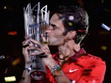 Roger Federer of Switzerland kisses the trophy after winning the Shanghai Masters on October 12, 2014