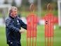 England manager Roy Hodgson looks truly petrified as two metal silhouettes attack him at St George's Park on October 8, 2014