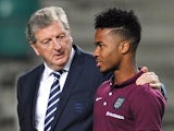 England manager Roy Hodgson (L) talks to midfielder Raheem Sterling at the A.Le Coq Arena in Tallinn, Estonia on October 11, 2014