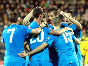 Slovenia's forward Milivoje Novakovic (2nd L) celebrates with his teammates after scoring during the Euro 2016 Group E qualifying football match Lithuania vs Slovenia in Kaunas, Lithuania on October 12, 2014