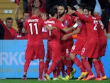 Turkey's forward Umut Bulut celebrates with teammates after scoring against Czech Republic during the UEFA Euro 2016 Group A qualifying football match between Turkey and Czech Republic on October 10, 2014