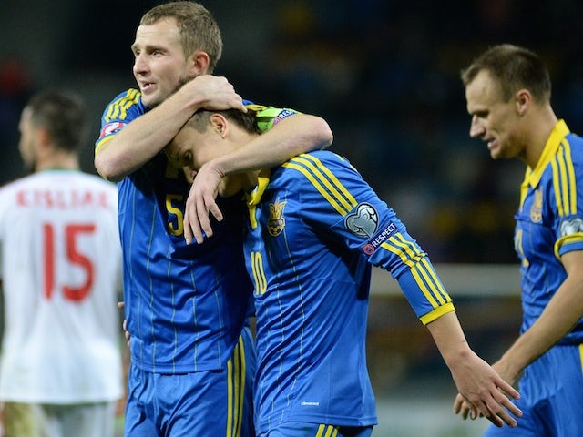 Ukraine's defender Oleksandr Kucher (L), forward Yevhen Konoplyanka (C) and defender Vyacheslav Shevchuk celebrate a goal on October 9, 2014 