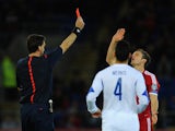 Wales player Andy King receives a straight red card from referee Manuel Grafe for a foul on Constantinos Makridis of Cyprus during the EURO 2016 Qualifier match on October 13, 2014