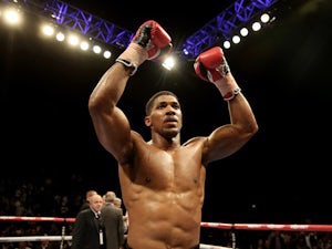 Joshua eases to third-round stoppage win
