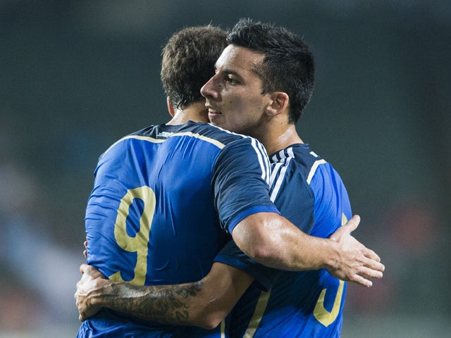 Gonzalo Higuain of Argentina celebrates with team mate Leonel Vangioni after scoring during the International Friendly Match between Hong Kong and Argentina at the Hong Kong Stadium on October 14, 2014
