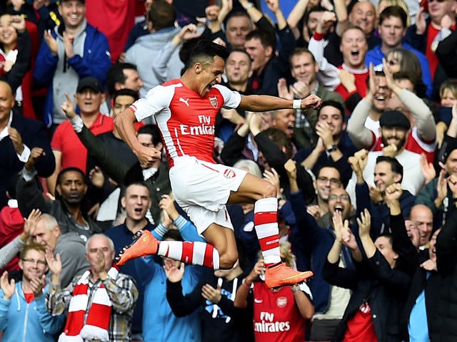 Alexis Sanchez of Arsenal celebrates after scoring the opening goal during the Barclays Premier League match between Arsenal and Hull City at Emirates Stadium on October 18, 2014