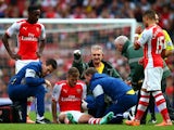 Jack Wilshere of Arsenal receives treatment after picking up an injury during the Barclays Premier League match between Arsenal and Hull City at Emirates Stadium on October 18, 2014