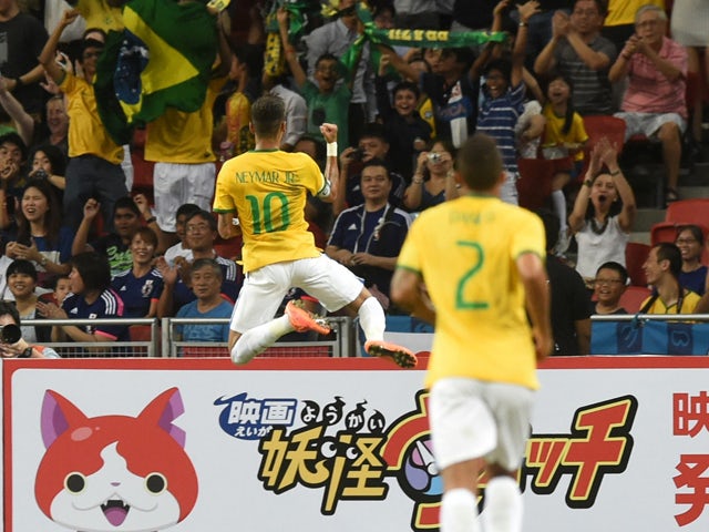 Brazil's forward Neymar celebrates his first goal in a friendly football match against Japan team at the National stadium in Singapore on October 14, 2014