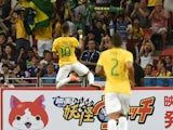 Brazil's forward Neymar celebrates his first goal in a friendly football match against Japan team at the National stadium in Singapore on October 14, 2014
