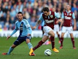 Danny Ings of Burnley is challenged by Morgan Amalfitano of West Ham during the Barclays Premier League match between Burnley and West Ham United at Turf Moor on October 18, 2014