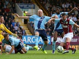 George Boyd of Burnley shoots past James Collins of West Ham to score his team's first goal during the Barclays Premier League match between Burnley and West Ham United at Turf Moor on October 18, 2014