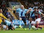 George Boyd of Burnley shoots past James Collins of West Ham to score his team's first goal during the Barclays Premier League match between Burnley and West Ham United at Turf Moor on October 18, 2014