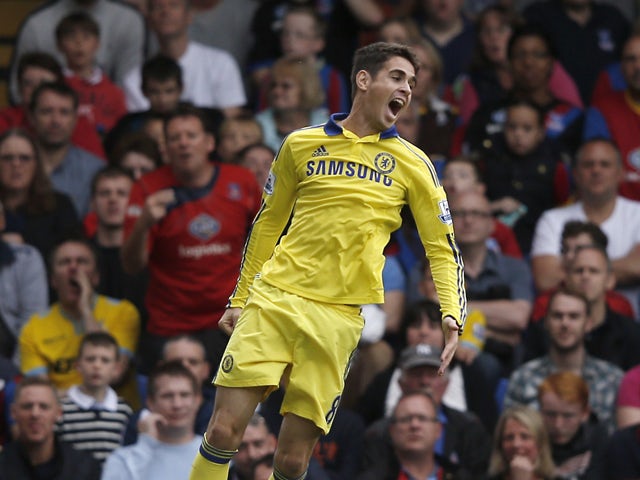 Chelsea's Brazilian midfielder Oscar celebrates scoring the opening goal during tthe English Premier League football match between Crystal Palace and Chelsea at Selhurst Park in south London on October 18, 2014