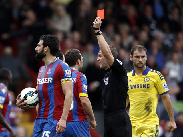 Referee Craig Pawson shows the red card to Crystal Palace's Irish defender Damien Delaney during the English Premier League football match between Crystal Palace and Chelsea at Selhurst Park in south London on October 18, 2014