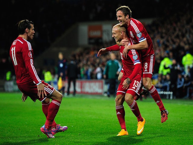 Wales player David Cotterill (c) celebrates his opening goal with Gareth Bale (l) and Andy King during the EURO 2016 Qualifier match against Cyprus on October 13, 2014