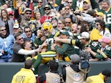 Jordy Nelson #87 of the Green Bay Packers celebrates with fans after a 59-yard touchdown pass reception in the first quarter of the game against the Carolina Panthers at Lambeau Field on October 19, 2014