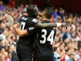 Mohamed Diame of Hull City celebrates with team-mate Hatem Ben Arfa after scoring their first goal during the Barclays Premier League match between Arsenal and Hull City at Emirates Stadium on October 18, 2014