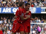 Liverpool's Brazilian midfielder Philippe Coutinho celebrates scoring his goal with Liverpool's English midfielder Steven Gerrard (L) during the English Premier League football match between Queens Park Rangers and Liverpool at Loftus Road in London on Oc