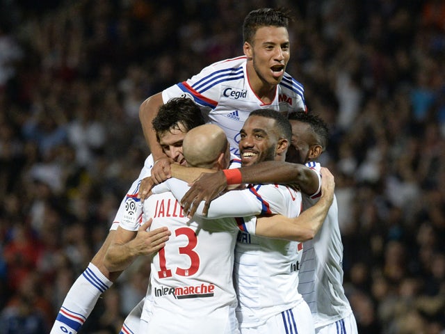 Lyon's French midfielder Yoann Gourcuff celebrates with his teammates after scoring a second goal during the French L1 football match Lyon (OL) vs Montpellier (MHSC) on October 19, 2014
