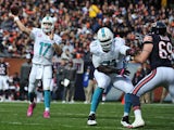 Ryan Tannehill #17 of the Miami Dolphins throws a touchdown pass as Branden Albert #71 of the Miami Dolphins blocks Jared Allen #69 of the Chicago Bears during the first quarter of the game at Soldier Field on October 19, 2014