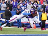 Cordarrelle Patterson #84 of the Minnesota Vikings scores a touchdown as Corey Graham #20 of the Buffalo Bills defends during the first half at Ralph Wilson Stadium on October 19, 2014