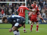 Ian Keatley of Munster celebrates withJJ Hanrahan after kicking the match winning drop goal during the European Rugby Champions Cup match between Sale Sharks and Munster at AJ Bell Stadium on October 18, 2014
