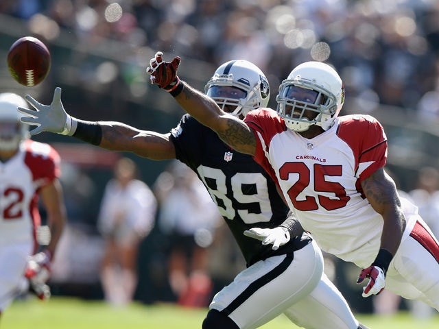 James Jones #89 of the Oakland Raiders misses a pass while being defended by Jerraud Powers #25 of the Arizona Cardinals at O.co Coliseum on October 19, 2014 