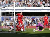 Liverpool's Slovakian defender Martin Skrtel clears the ball after a goal-mouth scramble during the Premier League match against Queens Park Rangers at Loftus Road on October 19, 2014