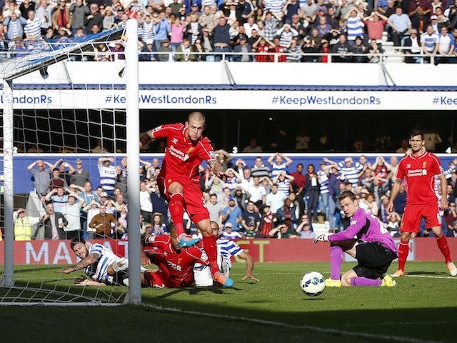 Liverpool's Slovakian defender Martin Skrtel clears the ball after a goal-mouth scramble during the Premier League match against Queens Park Rangers at Loftus Road on October 19, 2014