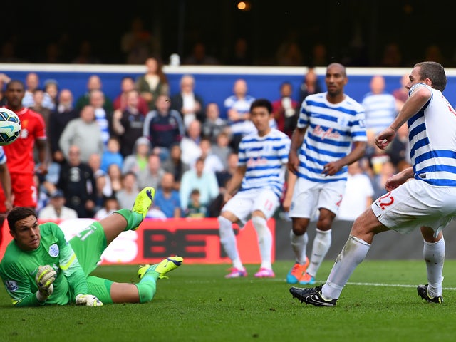 Richard Dunne of QPR scores an own goal past Alex McCarthy during the Barclays Premier League match between Queens Park Rangers and Liverpool at Loftus Road on October 19, 2014