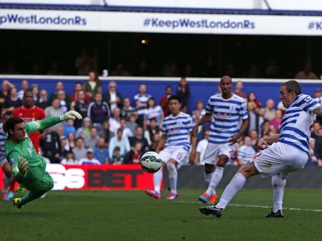Queens Park Rangers' Irish defender Richard Dunne diverts the ball into his own net past Queens Park Rangers' English goalkeeper Alex McCarthy to give Liverpool the lead during the English Premier League football match between Queens Park Rangers and Live