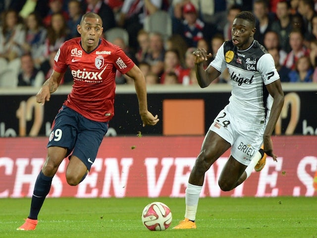 Lille's Brazilian forward Ronny Rodelin (L) vies with Guingamp's midfielder Sambou Yatabare during the French L1 football match Lille vs Guingamp on October 18, 2014