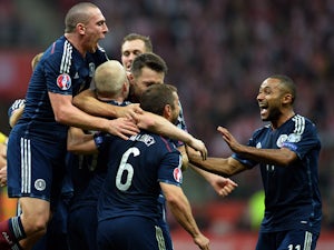 Scotland's players react after Steven Naismith scored a goal against Poland during the UEFA Euro 2016 Group D qualifying football match Poland vs Scotland in Warsaw, Poland on October 14, 2014