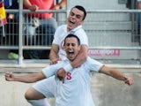 Aleksandar Pesic of Serbia celebrates with Filip Kostic after scoring during the 2015 UEFA European Under-21 Championship play-off football match between Spain and Serbia at the Carranza Stadium on October 14, 2014