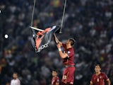 Serbia's defender Stefan Mitrovic grabs a flag with Albanian national symbols flown by a remotely operated drone during the UEFA Euro 2016 group F qualifying gootball match between Greece and Northern Ireland at the Karaiskaki stadium in Piraeus, near Ath