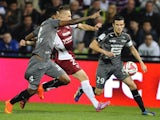 Metz' Belarussian midfielder Sergei Krivets (C) vies for the ball with Rennes' Mozambican defender Edson Mexer (L) and Rennes' French defender Romain Danze (R) during the French L1 match on October 18, 2014
