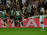 Sassuolo's forward Simone Zaza celebrates after scoring a goal with his team mates during the Serie A football match against Juventus on October 18, 2014