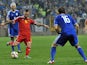Belgium's Steven Defour (C) strikes the ball, flanked by Bosnia and Herzegovina's Vedad Ibisevic (L) and Senad Lulic (R) during the Euro 2016 qualifying match on October 13, 2014