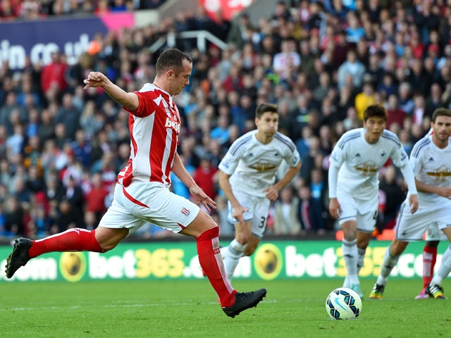 Stoke player Charlie Adam scores from the penalty spot during the Barclays Premier League match between Stoke City and Swansea City at Britannia Stadium on October 19, 2014