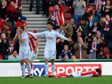 Victor Moses of Stoke City lies in the area as Angel Rangel of Swansea City (L) reacts after conceding a penalty, as Ki Sung-Yueng of Swansea City appeals to the Referee during the Barclays Premier League match between Stoke City and Swansea City at Brita