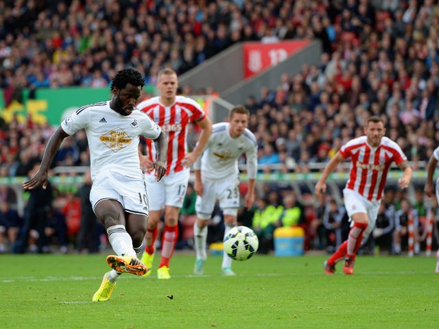 Wilfried Bony of Swansea City scores the first goal from the penalty spot during the Barclays Premier League match between Stoke City and Swansea City at Britannia Stadium on October 19, 2014