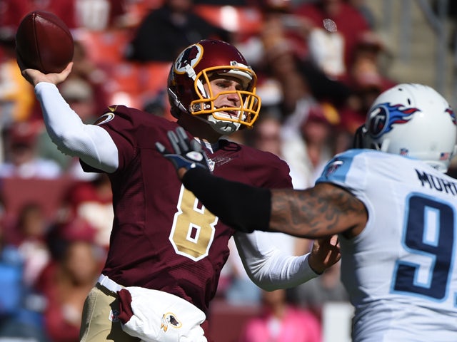 Kirk Cousins #8 of the Washington Redskins passes against Derrick Morgan #91 of the Tennessee Titans during first quarter at FedEx Field on October 19, 2014 