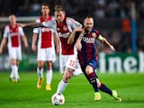 Andres Iniesta of FC Barcelona duels for the ball with Niki Zimiling of AFC Ajax during a UEFA Champions League Group F match on October 21, 2014
