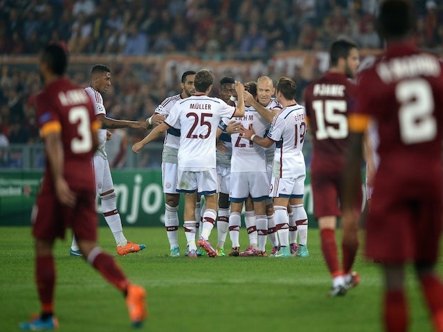 Bayern Munich's forward from Netherlands Arjen Robben (C) celebrates with teammates after scoring during the Champions League group stage football match AS Roma vs Bayern Munich on October 21, 2014