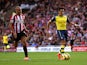 Alexis Sanchez of Arsenal outpaces Wes Brown of Sunderland to score the opening goal during the Barclays Premier League match between Sunderland and Arsenal at the Stadium of Light on October 25, 2014 